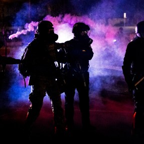 picture of protestors clashing with federal agents in Portland in July