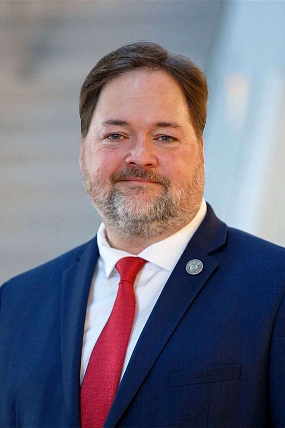 man wearing blue suit and red tie