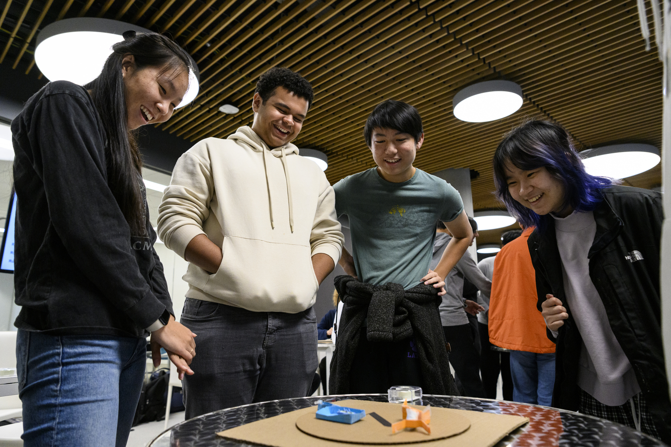 Four people stand together in a circle. 