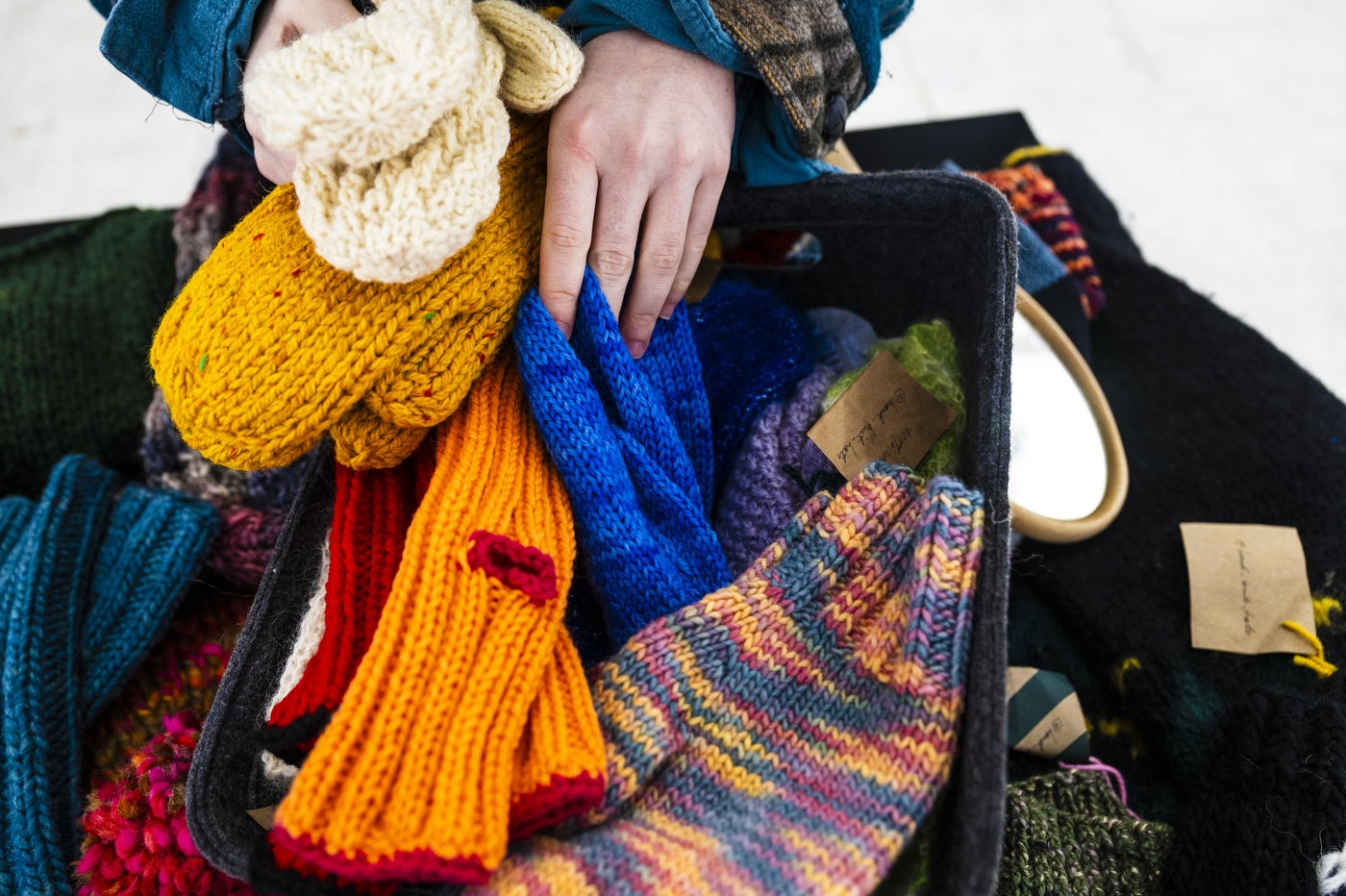 Rachel Harrell looking through knitted materials at the holiday market.