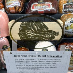 Deli meats and cheese in a glass display.