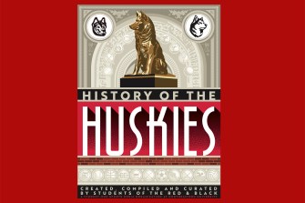 Cover of “History of the Huskies,” a 250-page coffee table book created by Northeastern students, featuring a bronze husky statue and university symbols.