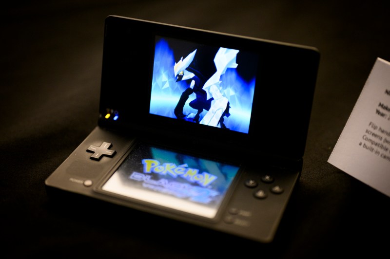 A black Nintendo DS gaming device with a Pokemon game on the screen.