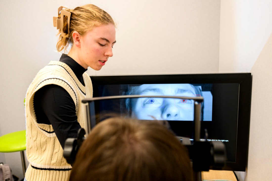 Ariana Mechem standing in front of another person who is doing behavioral therapy.