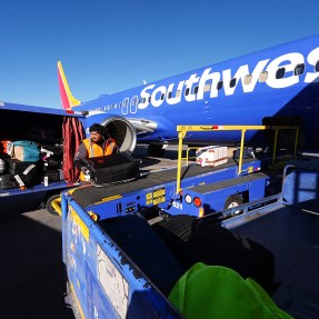 A blue airplane with 'southwest' written on it.