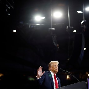 Donald Trump speaking on stage at an event.
