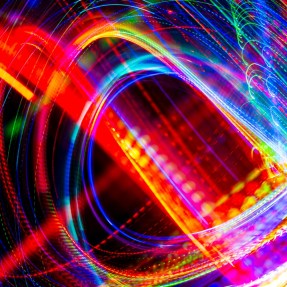 Digital lines of various colors swirling across a black background.