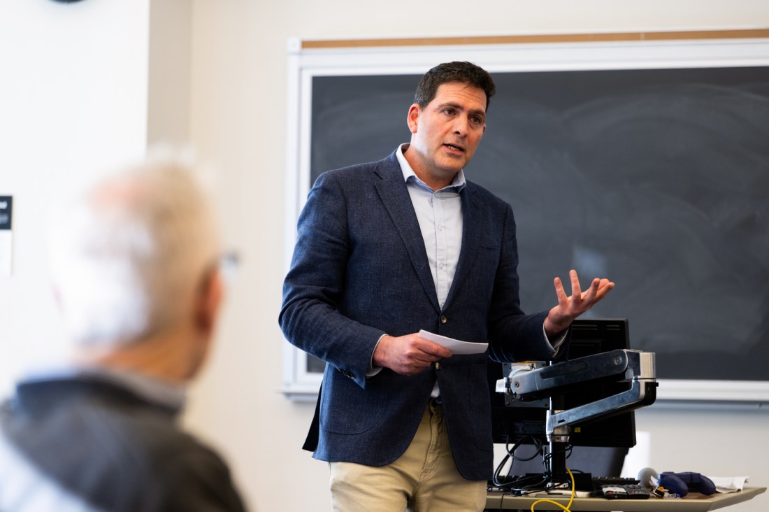 A professor speaks during a panel with alumni and entrepreneurs from startup program.