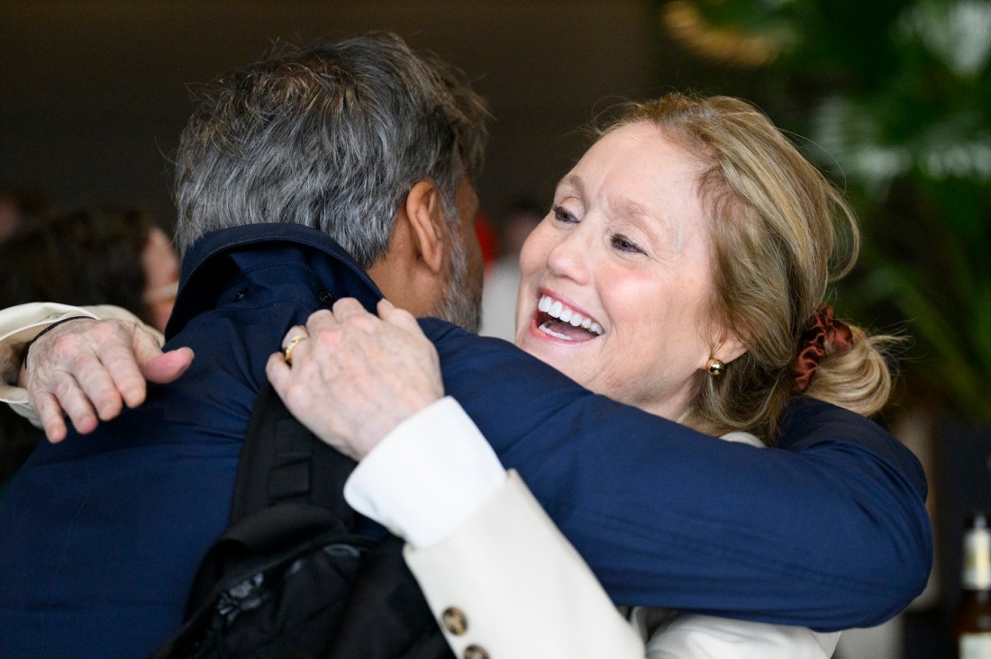 Two Northeastern community members hugging.