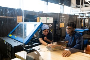 Two high school students working in the EXP Makerspace on Northeastern's Boston campus.