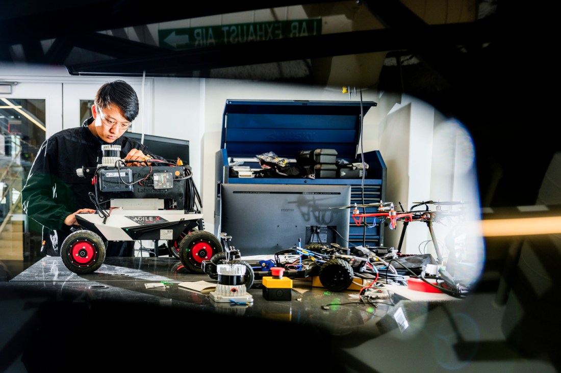 Zihao Dong installing an autonomy kit on a robot.