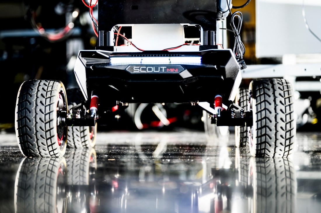 A robot with four wheels that has 'Scout Mini' branded on it.
