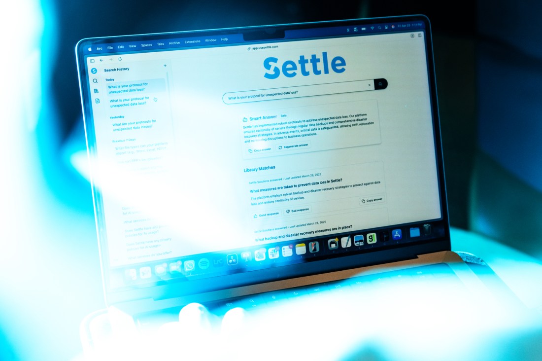 A laptop screen open to the website of the Settle company.