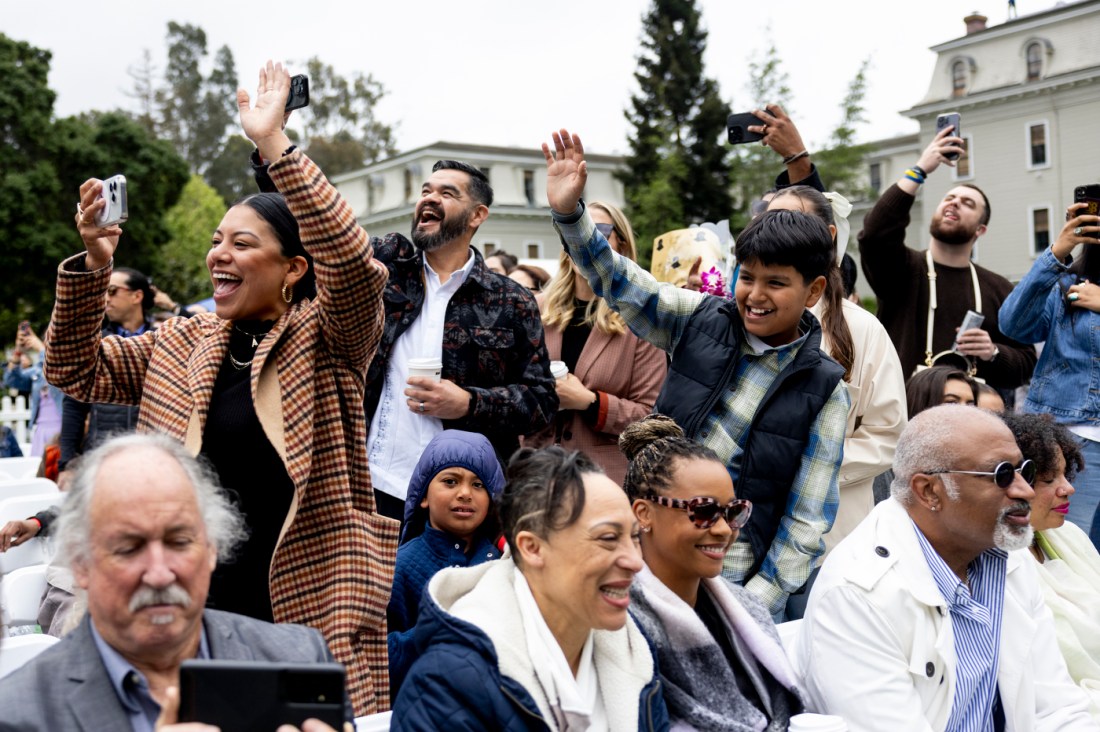 Friends and family members cheering for the graduates. 