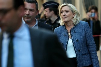 Marine Le Pen leaving a building.