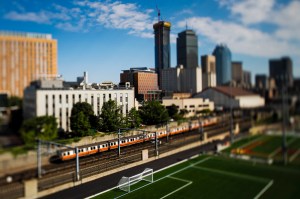 The orange line MBTA train running past Carter Playground with the Boston skyline in the background.