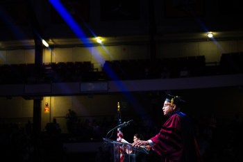 Ralph Martin standing at a podium on stage at the Law School commencement.