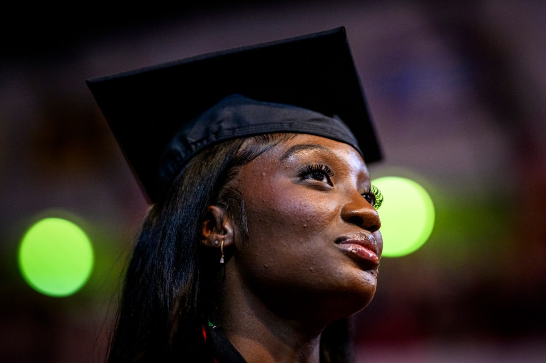 Graduate smiles during the Bouve College of Health Sciences commencement ceremony.