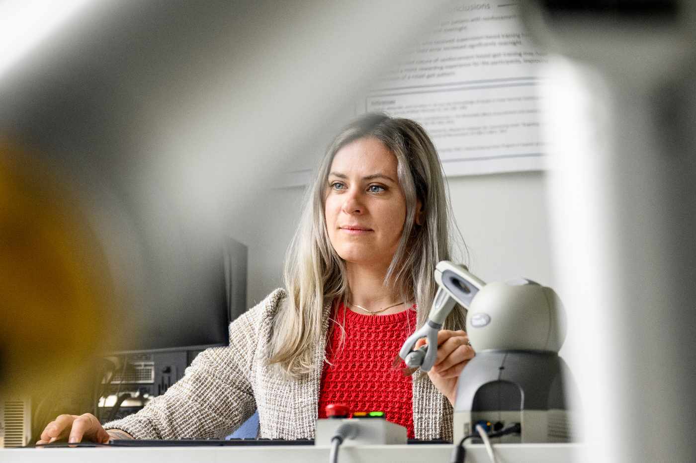 Julia Manczurowsky sitting in a biomechanics lab using motion capture equipment and monitors.