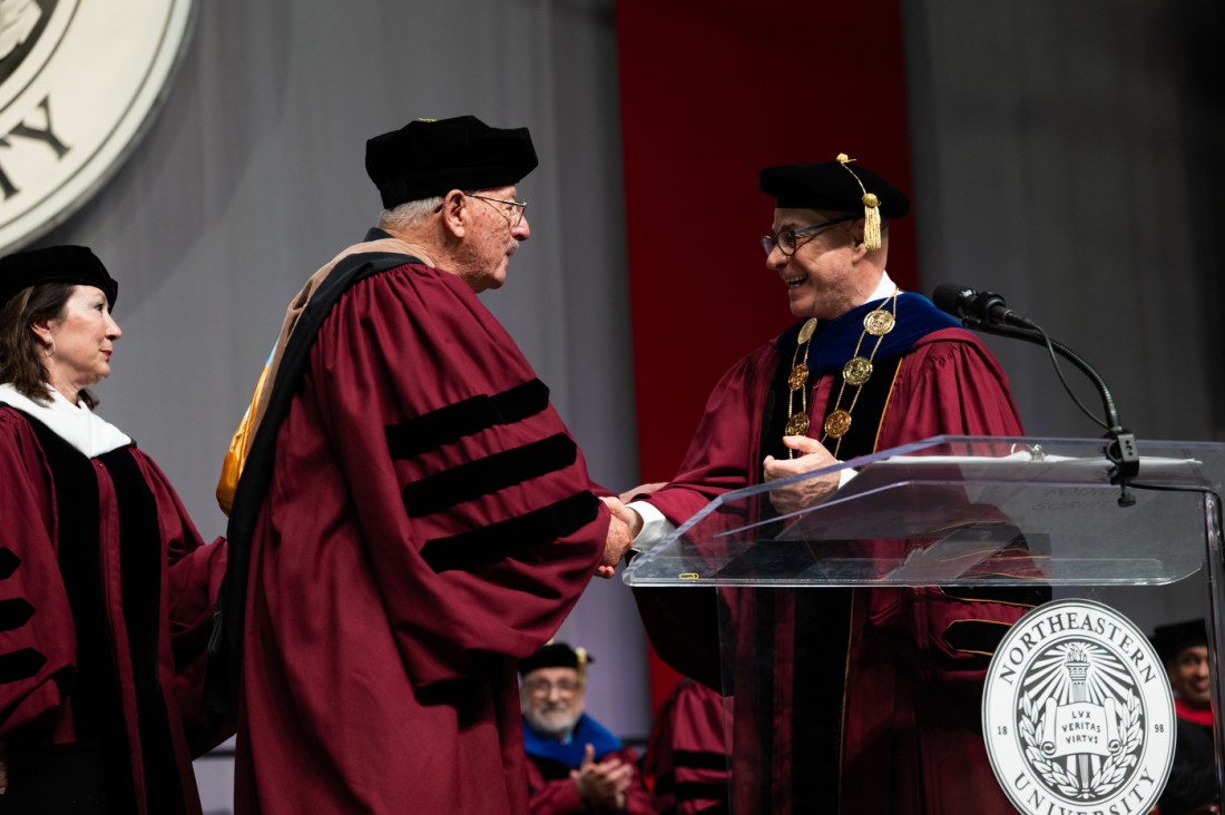Northeastern University leaders present the Pioneer Award during the D’Amore-McKim School of Business Undergraduate Commencement ceremony at Matthews Arena.