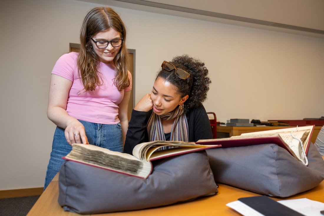 Two students examine a manuscript at Lambeth Palace Library in London.