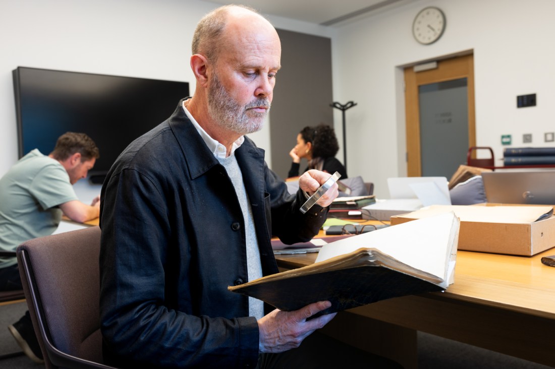 A researcher examines rare documents during archival research at Lambeth Palace Library in London.