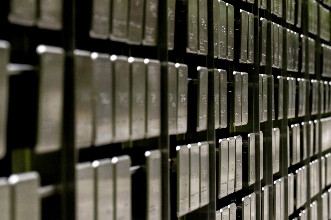 Rows of dog tags hanging in a line on a wall as part of the Veterans Memorial on Northeastern's Boston campus.