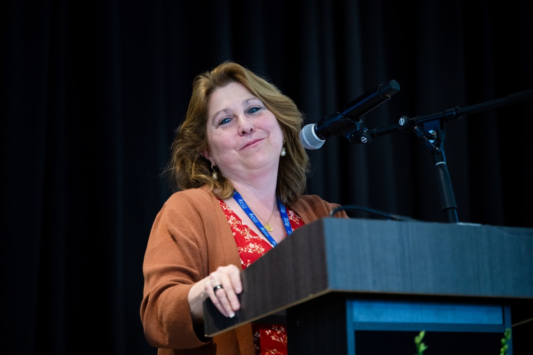 A speaker at a podium addresses the audience at the 27th annual Boston Public School Valedictorian Luncheon at Fenway Park. 