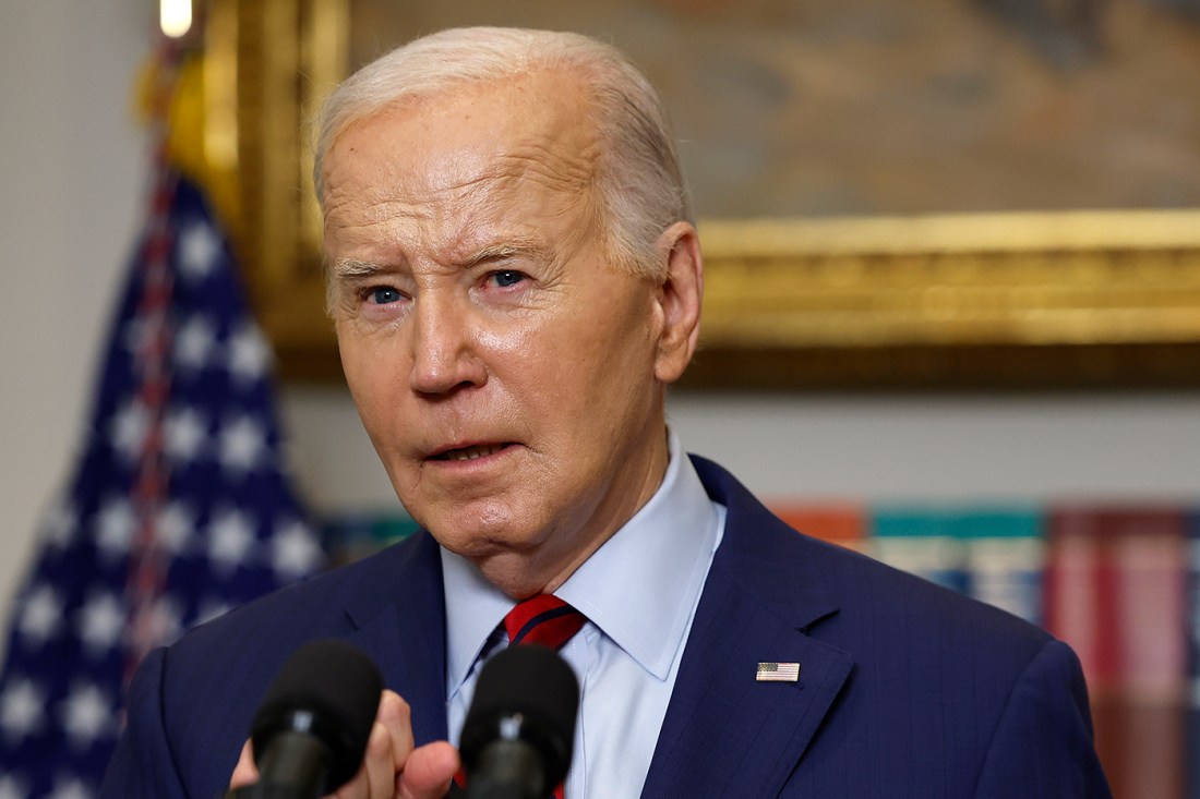 Former President Joe Biden standing at a podium.