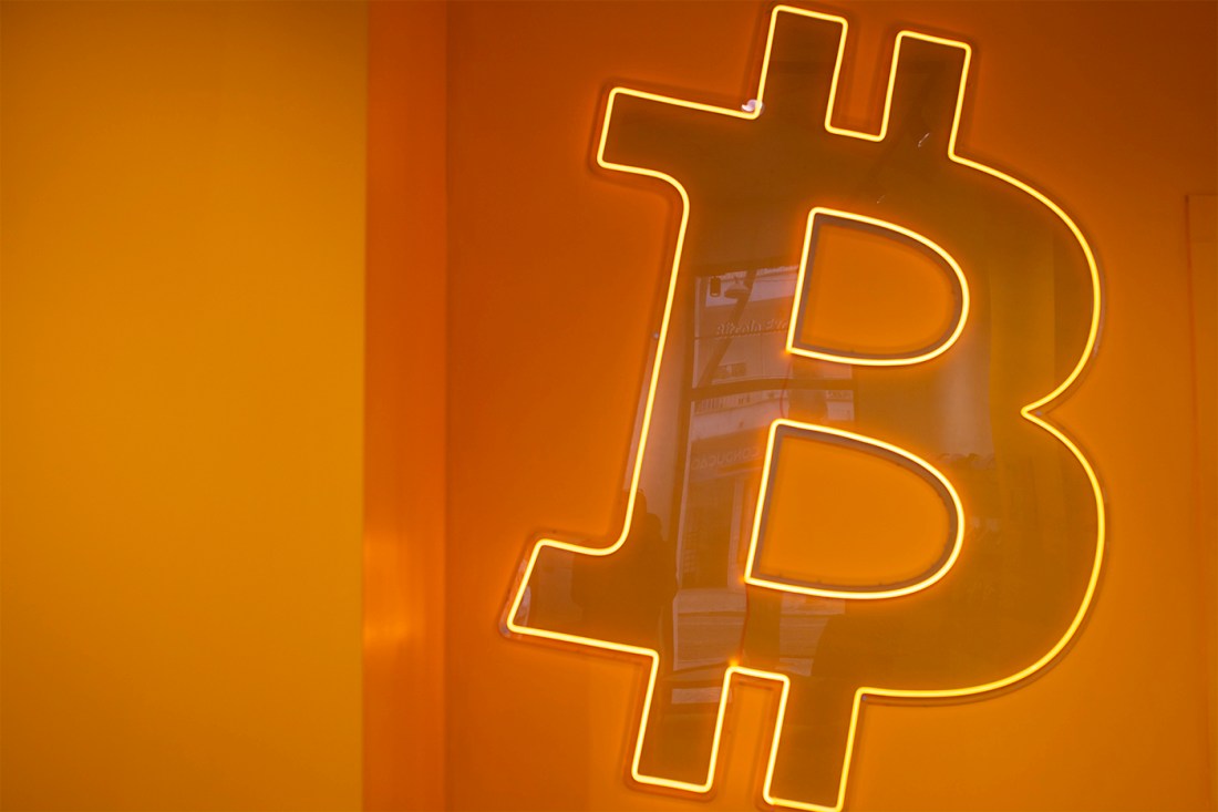 An image of the logo to a cryptocurrency known as Bitocin against an orange backdrop.