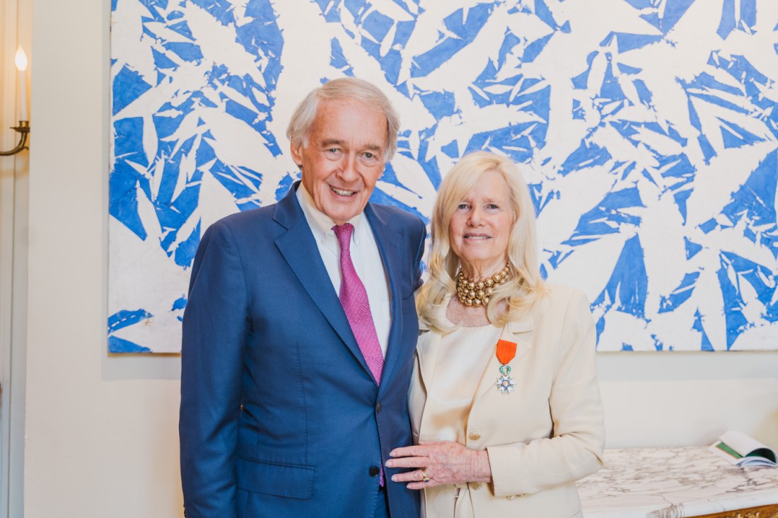 Ed Markey and Susan Blumenthal pose with a medal pinned to her chest.