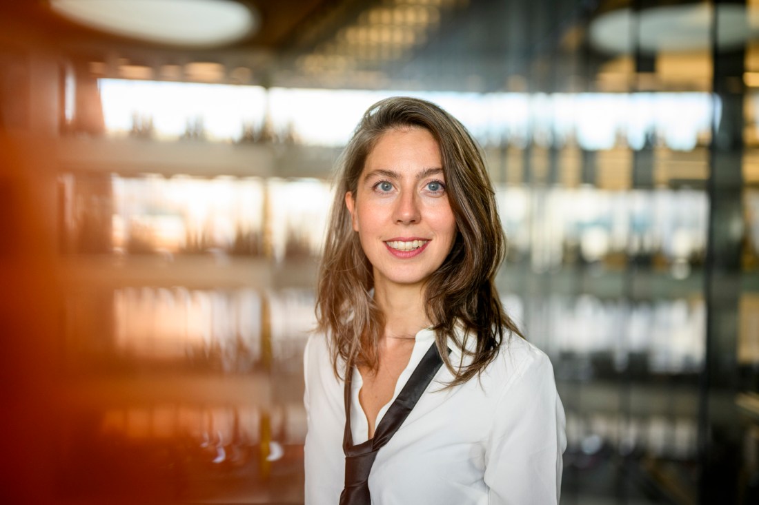 Portrait of Cansu Canca with a white button down and a black tie. 