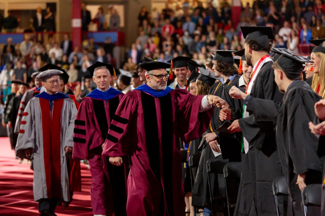 Engineering faculty and graduates process into a commencement ceremony.
