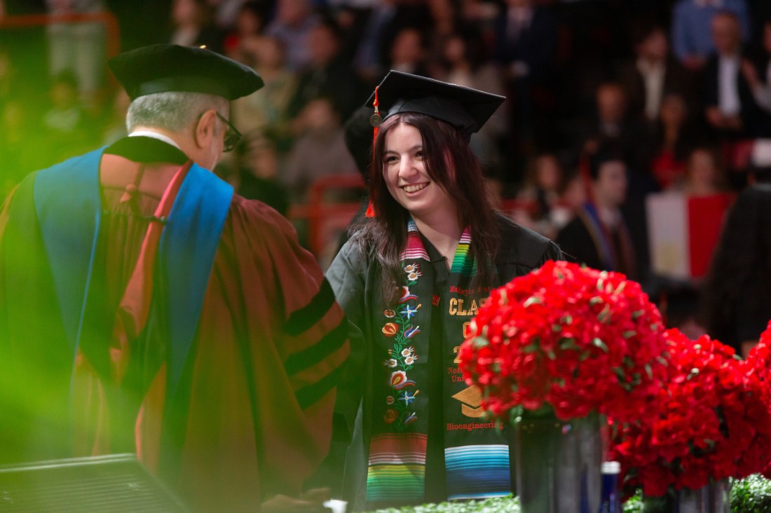 A graduate shakes Stephen Lynch's hand.