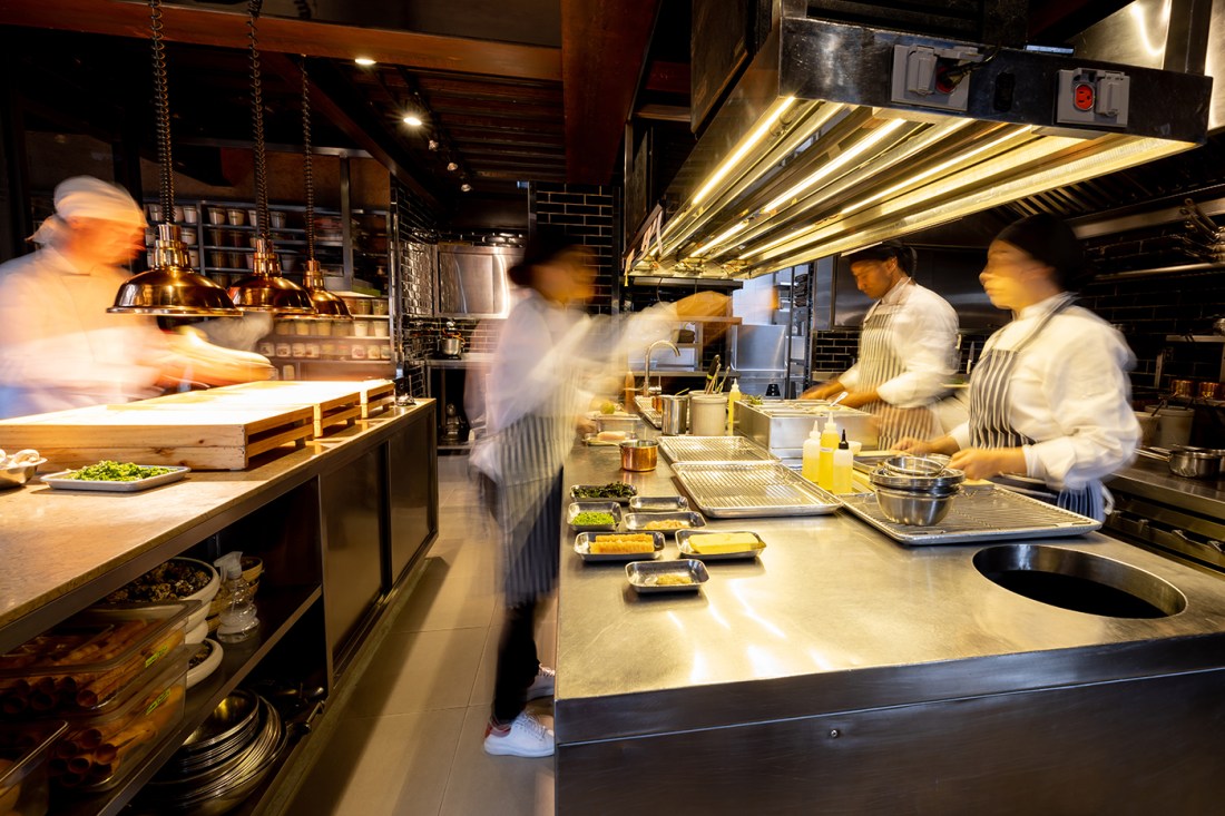 A time lapse of cooks working in a restaurant.