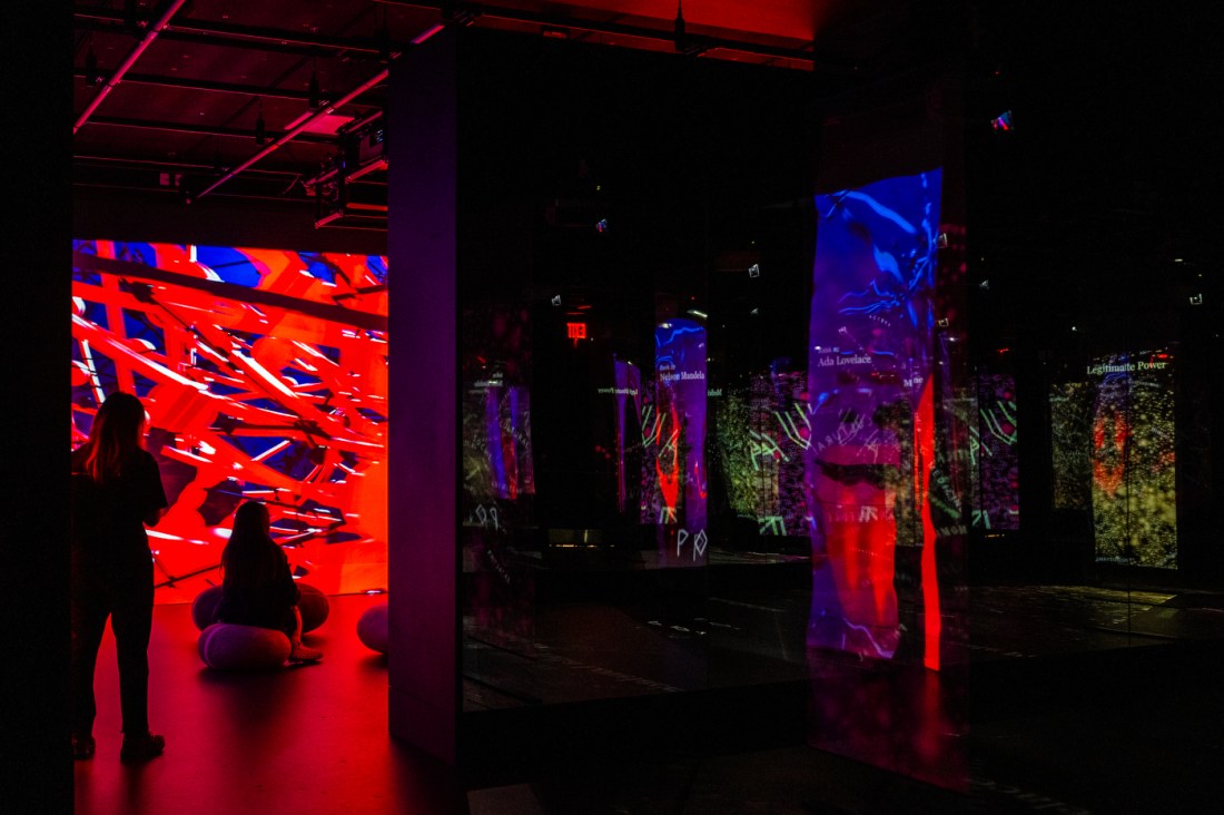 Digital projections represent the spread of COVID misinformation in a vivid immersive art installation.