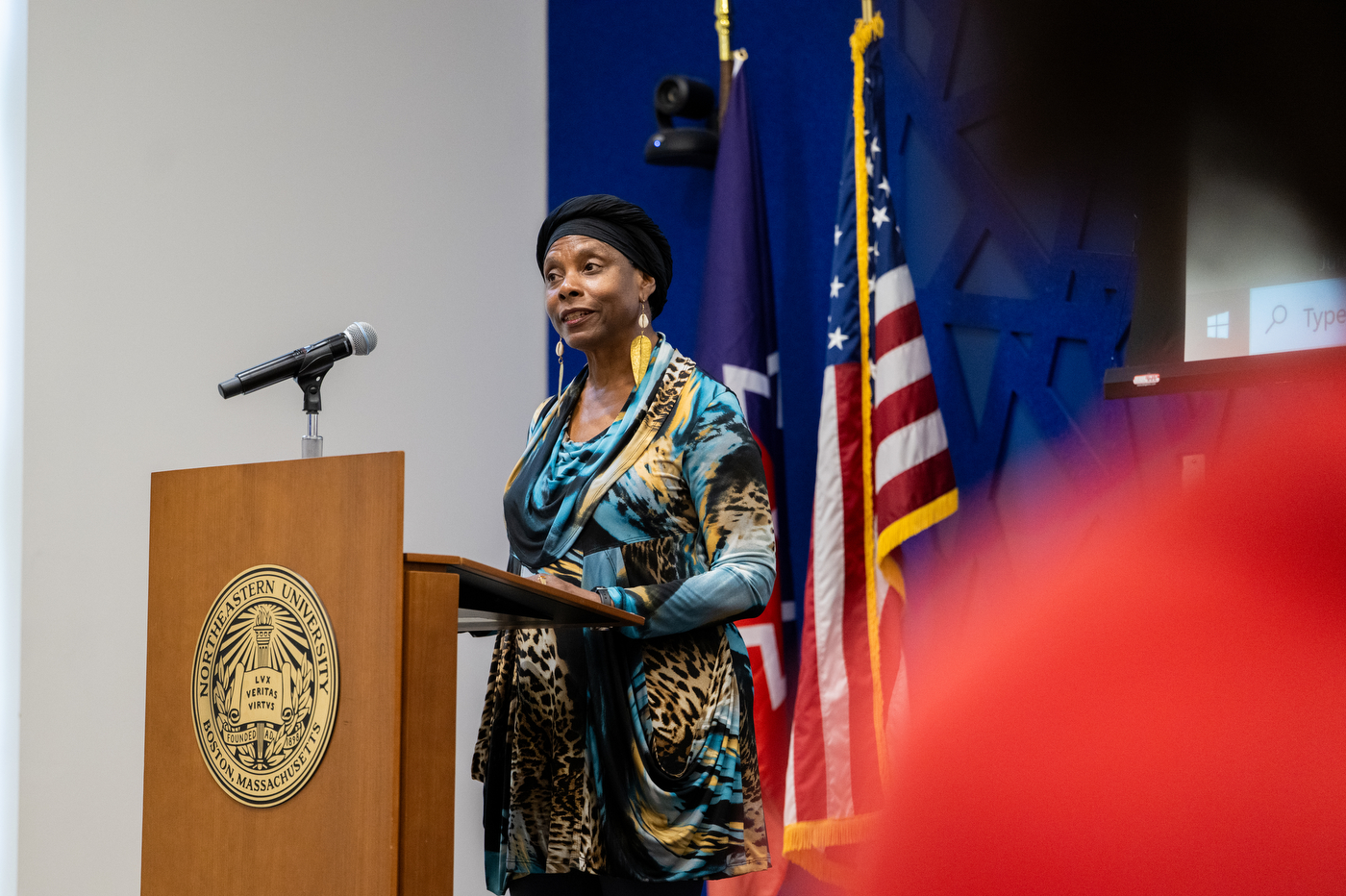 A speaker addresses the audience during a university event.

