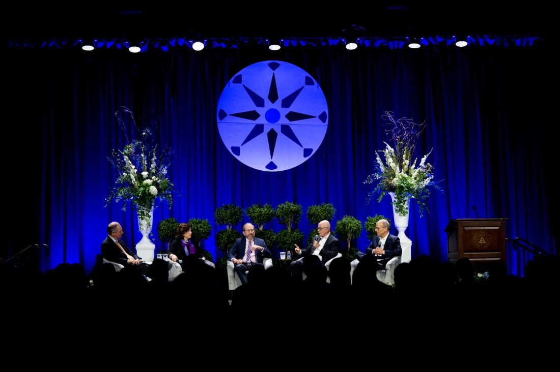 Speakers take part in a panel discussion at an education conference.