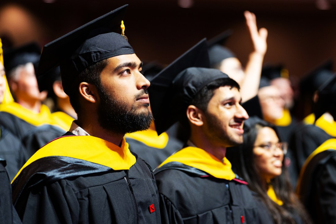Students in caps and gowns attend the Northeastern commencement in Portland.