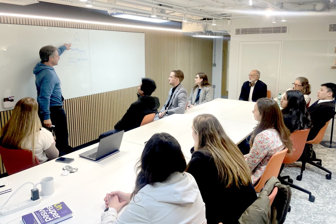 Students watch a presentation in a conference room.