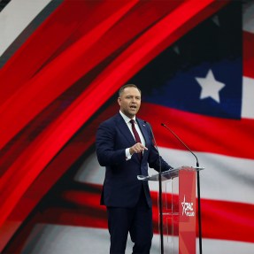 Karol Nawrocki standing on stage speaking passionately.