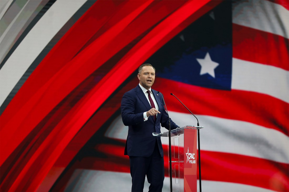 Karol Nawrocki standing on stage speaking passionately.
