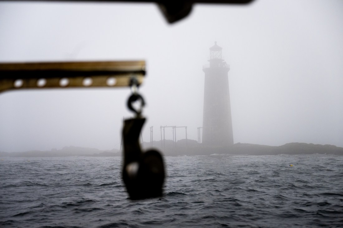 A lighthouse seen in the fog. 