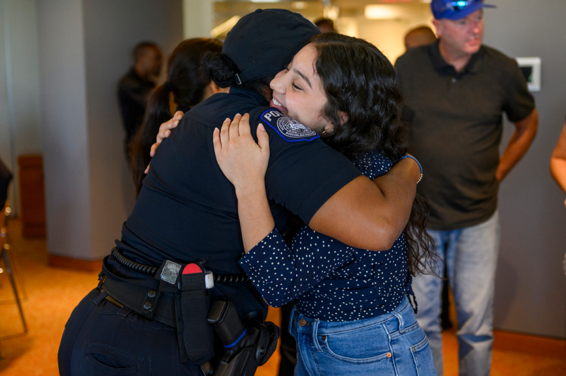 Someone hugging a police officer