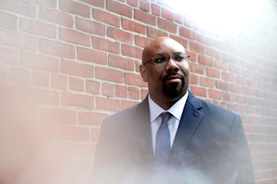 Portrait of Marcus Howard wearing a suit and tie.