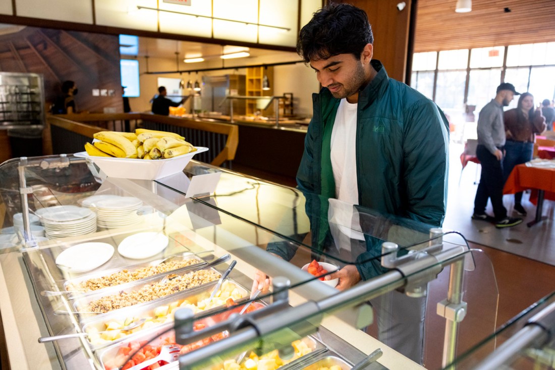 A student taking food from a salad bar