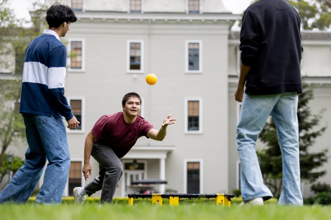 Students playing Spikeball on a quad