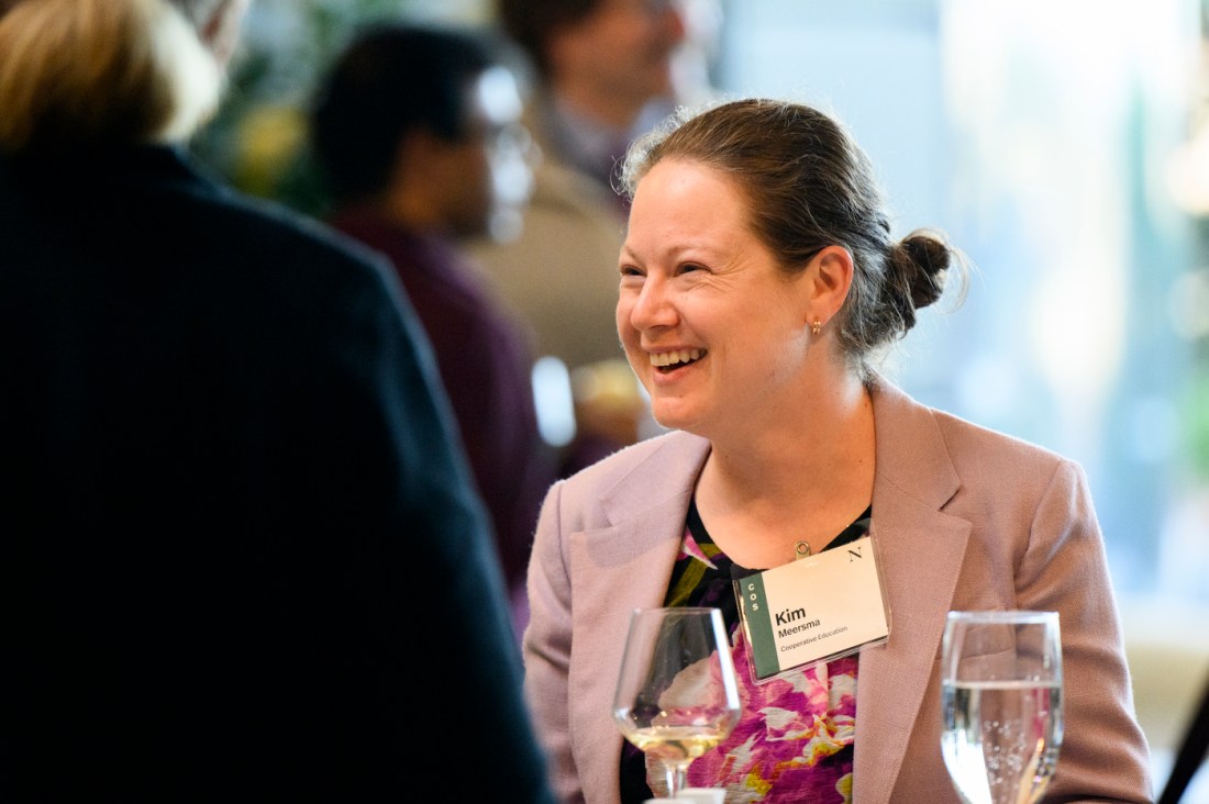 A female faculty member, Kim Meersma, shown smiling while in conversation.