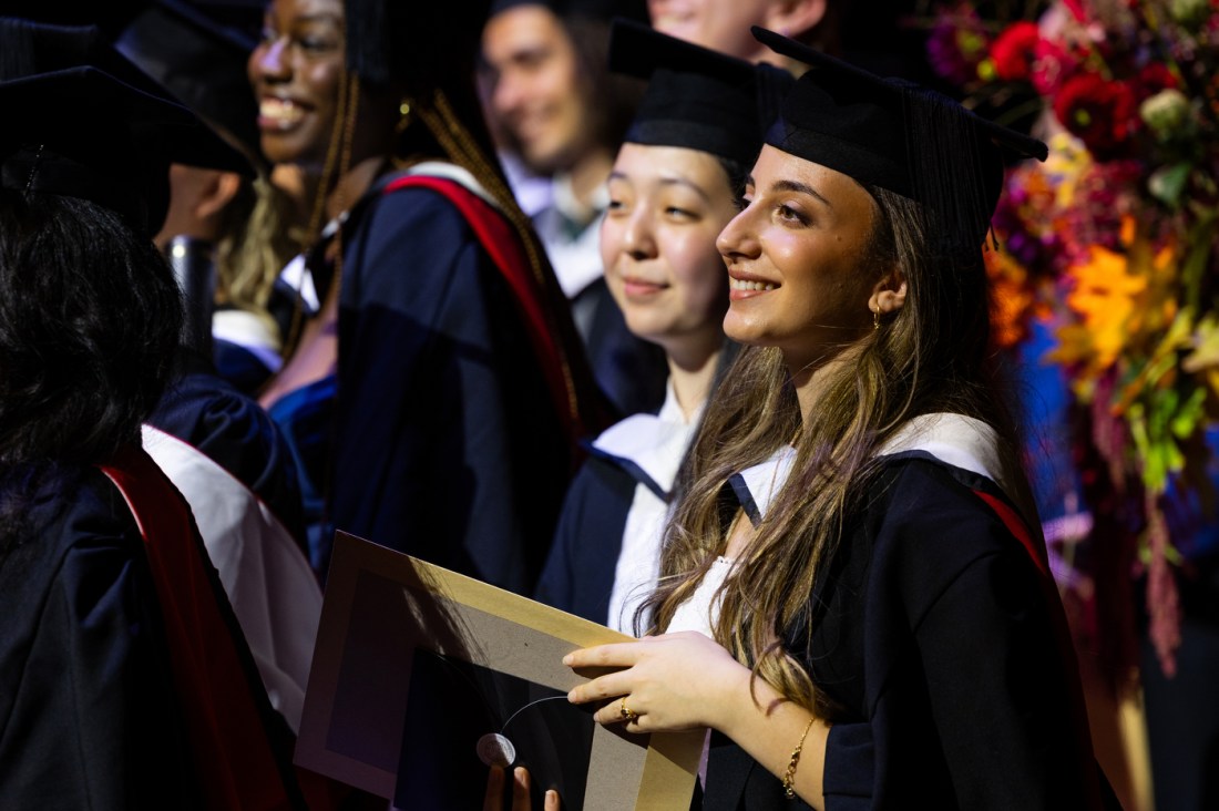 Graduates exchange congratulations and smiles following the Northeastern London commencement ceremony.